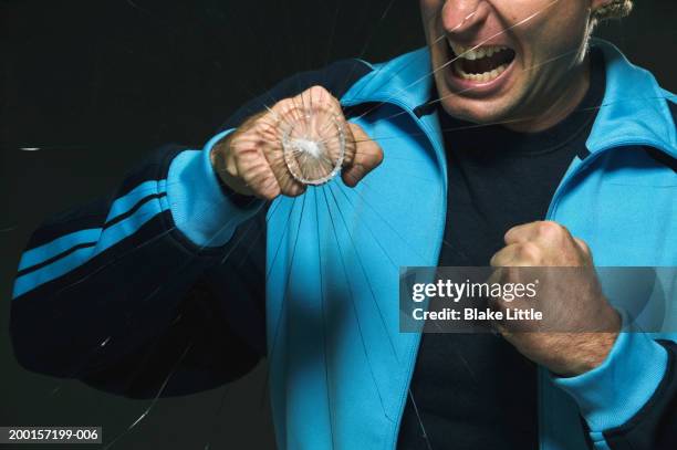 man punching on glass,  glass cracking - punching glass stock pictures, royalty-free photos & images