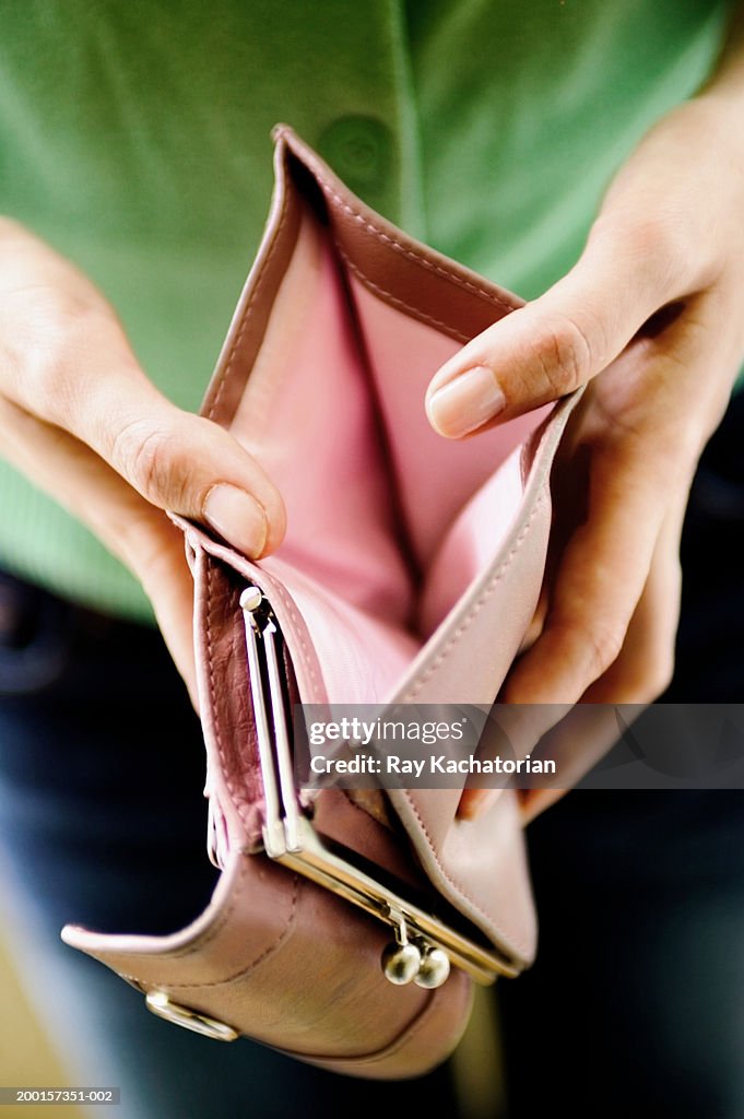 Woman opening empty wallet