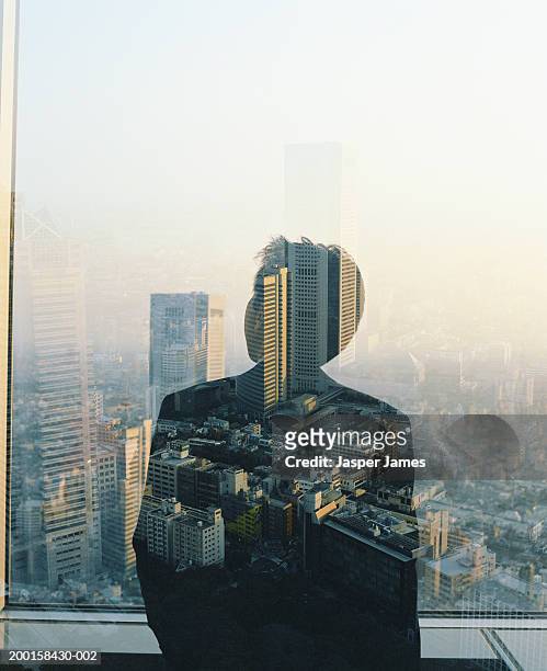 businessman at window overlooking cityscape (multiple exposure) - double exposure business stock pictures, royalty-free photos & images