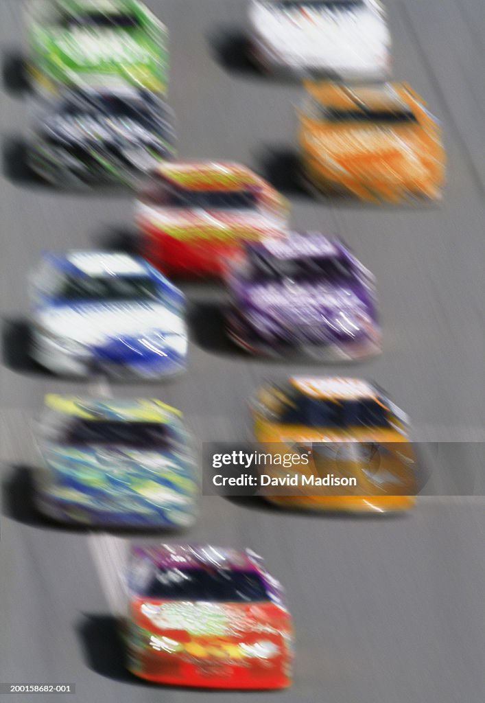 Stock cars on straight-away, elevated view (blurred motion)