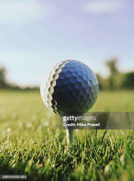 golf ball on tee, close-up - golf ball tee stock pictures, royalty-free photos & images