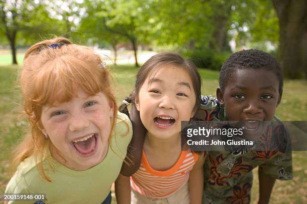 kids (6-8) making faces, smiling, portrait - child hugging tree stock pictures, royalty-free photos & images