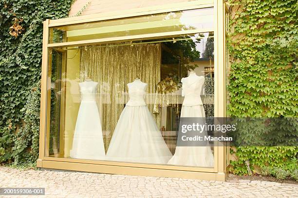 wedding dresses on mannequins in shop window - wedding dress store stock pictures, royalty-free photos & images