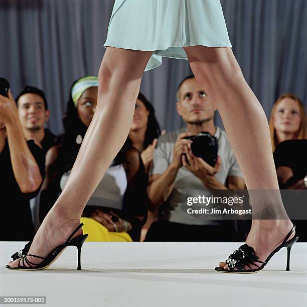 fashion model walking on catwalk, audience in background, low section - leg show stock pictures, royalty-free photos & images