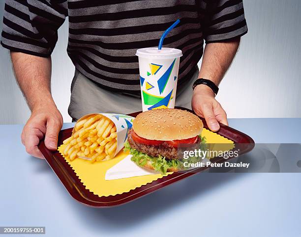 man holding tray with fast food meal, close-up - man tray food holding stockfoto's en -beelden