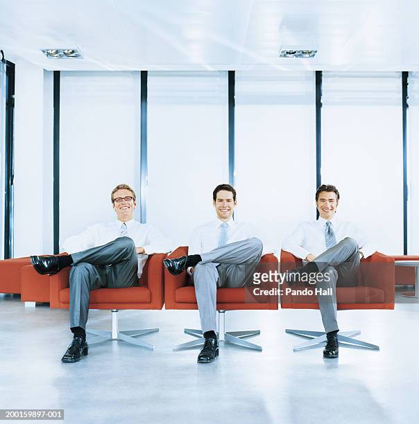 three businessmen sitting in armchairs, smiling, portrait - chaise lounge bildbanksfoton och bilder