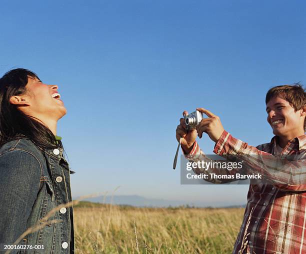 man taking digital photograph of young woman, laughing - head back stock pictures, royalty-free photos & images