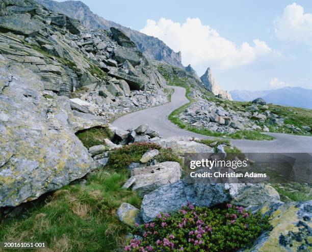 winding road on rocky cliff - travel11 stock pictures, royalty-free photos & images