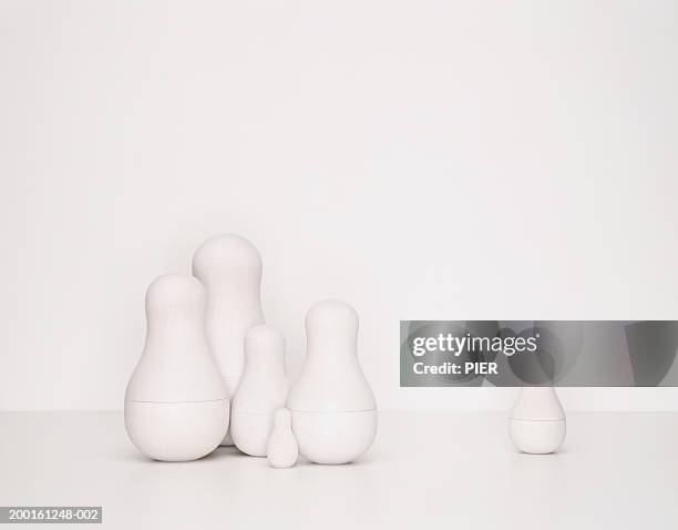 set of undecorated russian dolls, one separated from group - russian nesting doll stock pictures, royalty-free photos & images