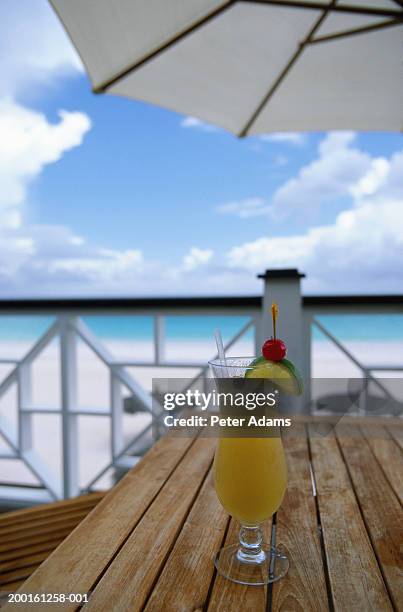 cocktail on table, on balcony overlooking beach - travel12 stock pictures, royalty-free photos & images