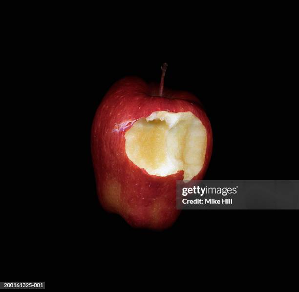 red delicious apple with bite-size chunk missing, close-up - bite mark stock pictures, royalty-free photos & images