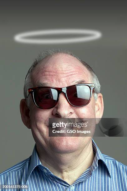 senior man wearing sunglasses with halo of light above head, portrait - man angel wings stock pictures, royalty-free photos & images