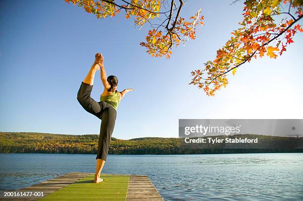 woman practicing yoga on dock, rear view, sunset - lake solitude (new hampshire) stock pictures, royalty-free photos & images