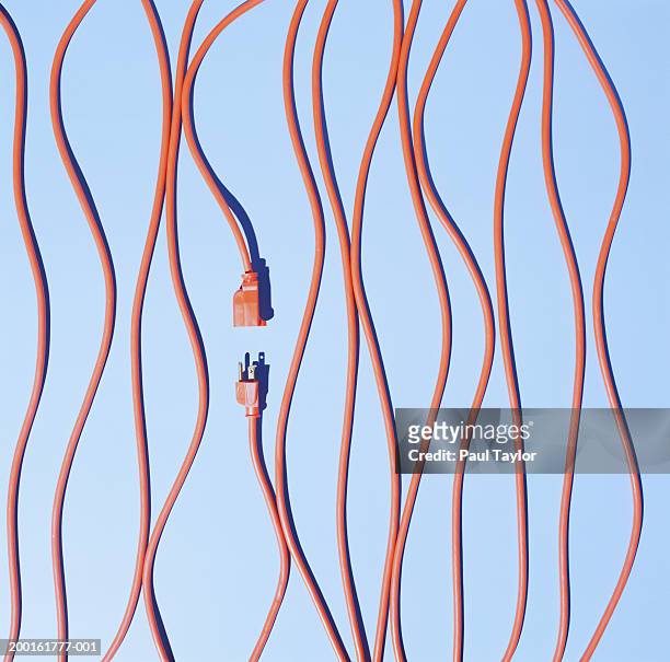 orange extension cords, elevated view - separation foto e immagini stock