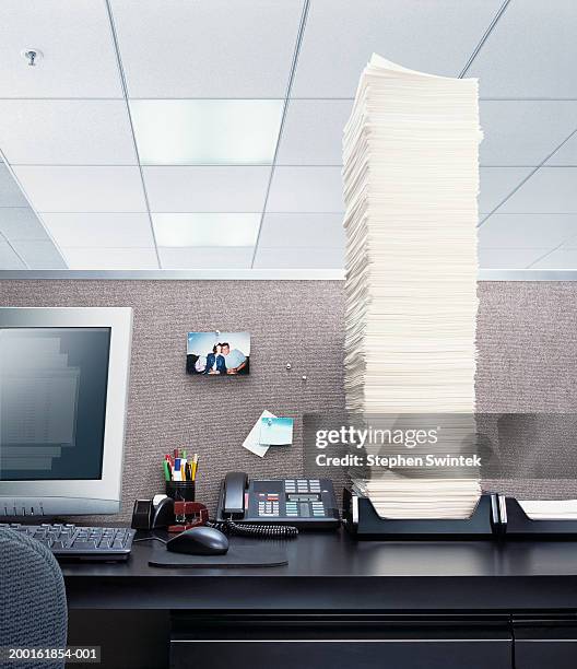 office desk with papers piled high in 'in' box - sicurezza-sul-posto-di-lavoro foto e immagini stock