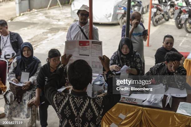 Electoral officials count ballots at a polling station in South Tangerang, Banten, Indonesia, on Wednesday, Feb. 14, 2024. Indonesia's Defense...