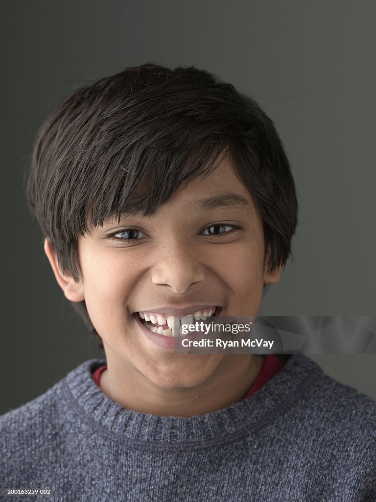 Boy (8-10) smiling,  portrait