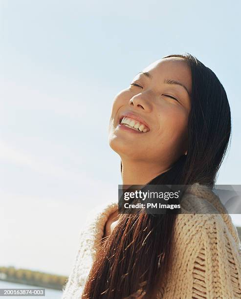 young woman outdoors, smiling - huvudet bakåt bildbanksfoton och bilder