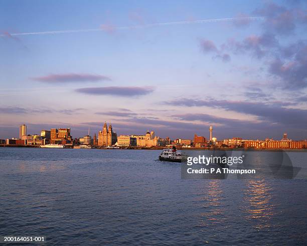 england, merseyside, liverpool skyline, ferry on river mersey - merseyside ストックフォトと画像