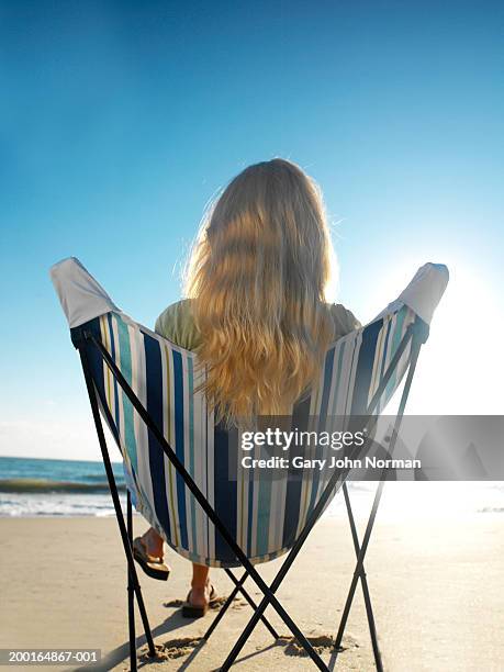 woman sitting in beach chair, rear view - travel12 stock pictures, royalty-free photos & images