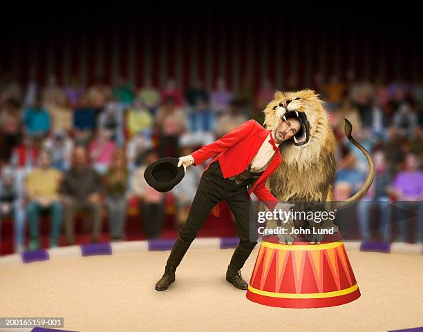 lion trainer's head inside lion's mouth (digital composite) - lion expression stock pictures, royalty-free photos & images