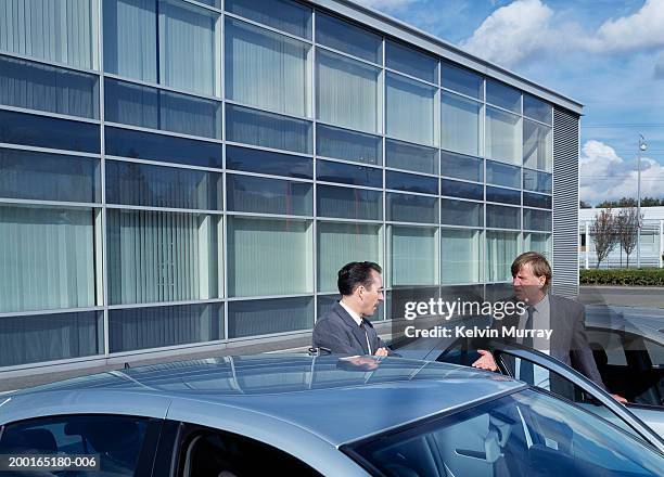 businessmen talking by cars, outdoors - bad parking job stock pictures, royalty-free photos & images