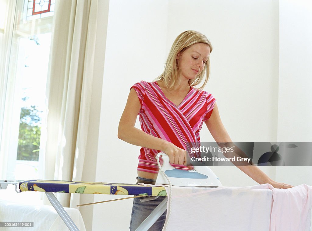 Young woman doing ironing