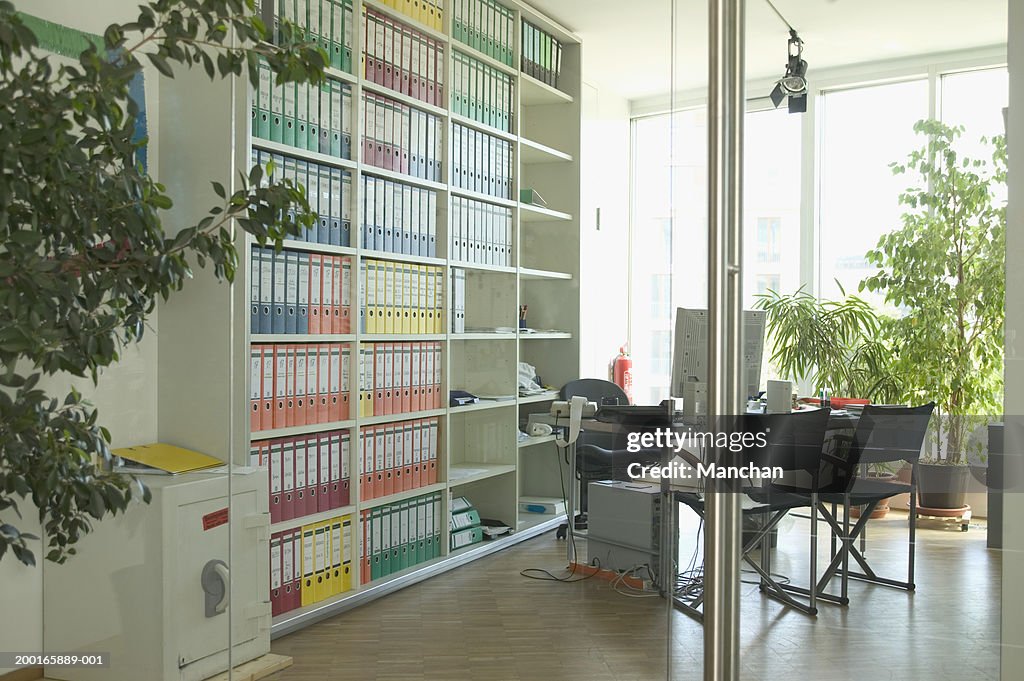 Office with filing shelves and desk
