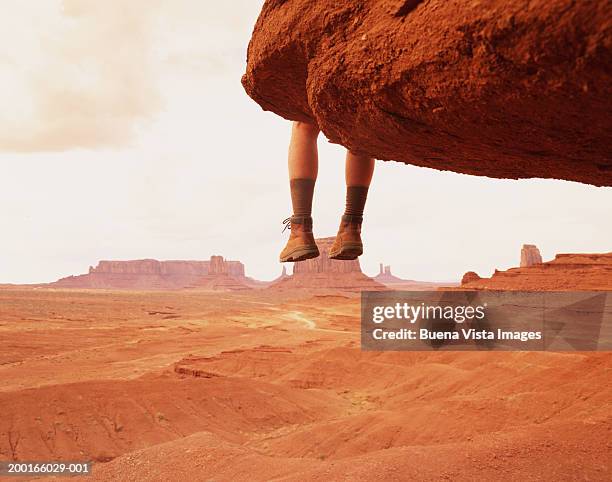 usa, arizona, man sitting on edge of rock formation, low section - 2004 fotografías e imágenes de stock