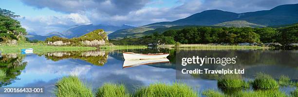 ireland, co. kerry, killarney lakes, empty row boats on lake - killarney lake stock pictures, royalty-free photos & images