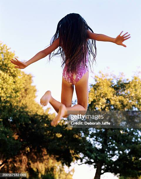 Girl In Swimsuit Jumping Rear View High-Res Stock Photo - Getty Images