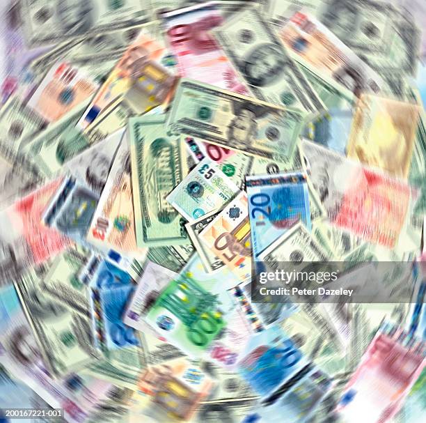 bank notes of various currency, overlaid, spinning (blurred motion) - ten pound note ストックフォトと画像