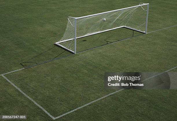 empty football pitch, ball in goal, elevated view - soccer field stock-fotos und bilder