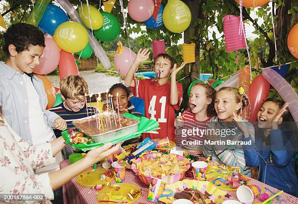 group children (9-12) at birthday party outdoors - birthday party stockfoto's en -beelden