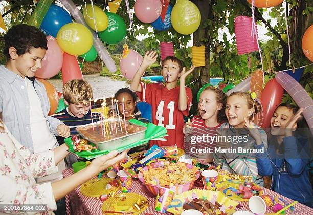 group children (9-12) at birthday party outdoors - kids birthday stock pictures, royalty-free photos & images