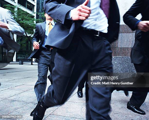 group of businessmen running from building - terrified stock pictures, royalty-free photos & images