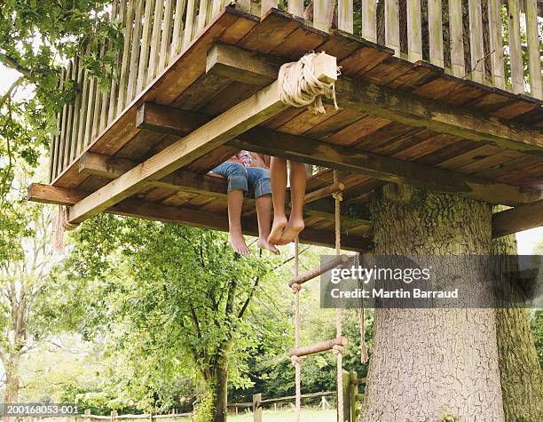 two girls (9-11) sitting in tree house, low section, low angle view - tree house bildbanksfoton och bilder