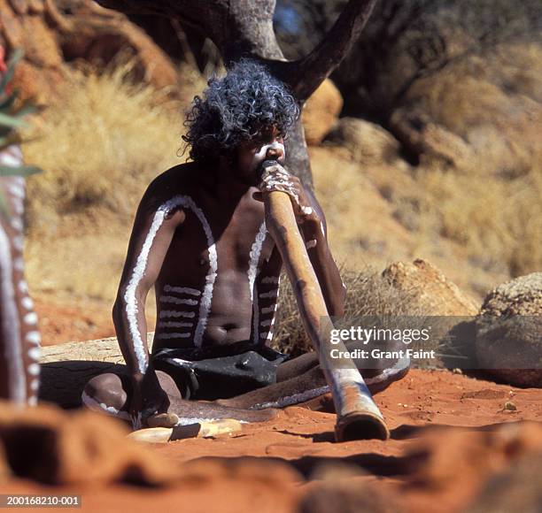 australia, alice springs,  aboriginal man playing dide - traditionally australian stock pictures, royalty-free photos & images