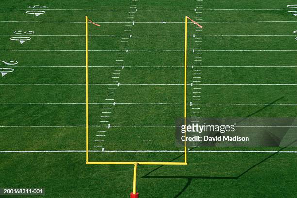 american football field with goal post, elevated view - goalpost stock-fotos und bilder
