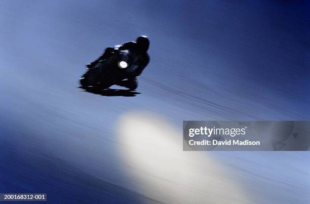 motorcycle racer speeding around turn (blurred motion) - motorcycle racing stock pictures, royalty-free photos & images