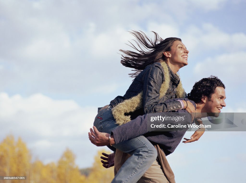 Man Giving Young Woman Piggyback Ride Smiling Side View High-Res Stock  Photo - Getty Images