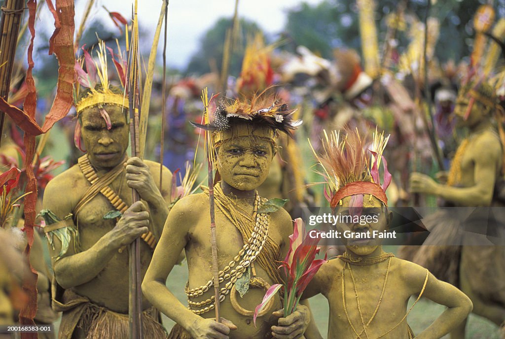 Father with sons (6-10) in tribal costume, portrait