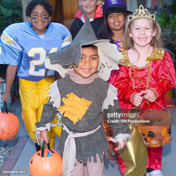 children (4-8) in halloween costumes trick-or-treating - girl american football player stock pictures, royalty-free photos & images