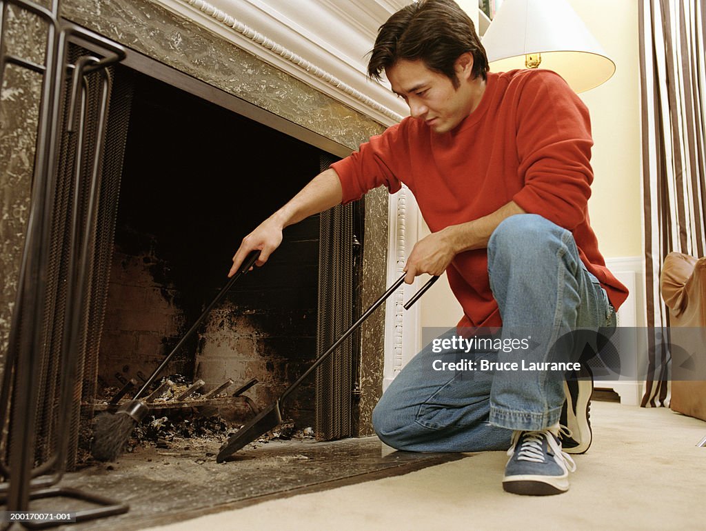 Man cleaning out fireplace