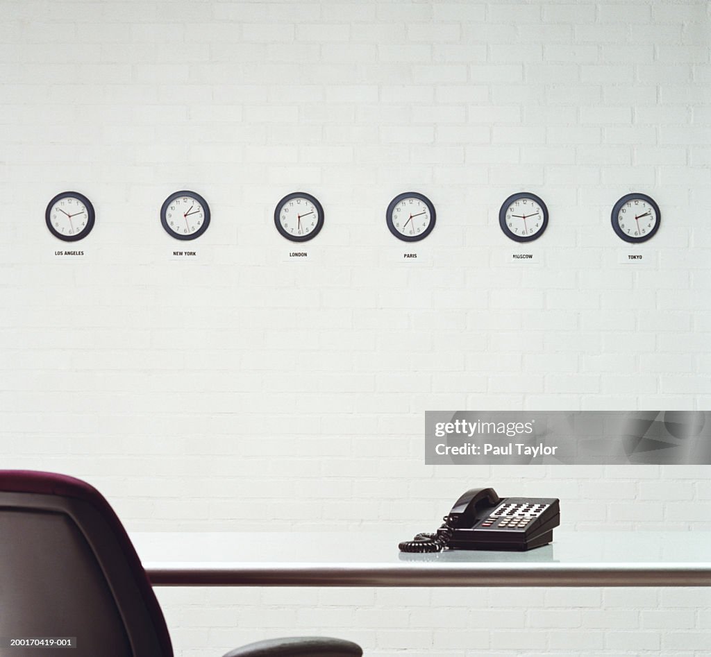 Different time zone clocks on wall in office
