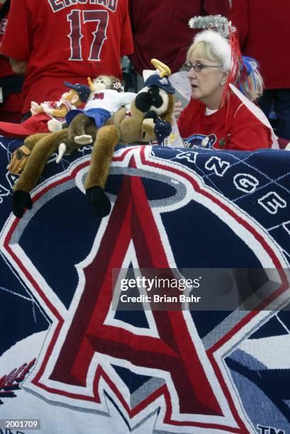 Female fan of the Anaheim Angels displays various rally monkeys on her giant Angels towel from the front row during game seven of the World Series...