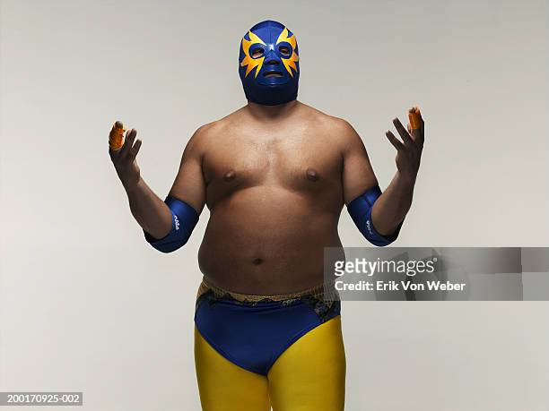 man wearing wrestler costume, holding hands up - wrestling men stock pictures, royalty-free photos & images