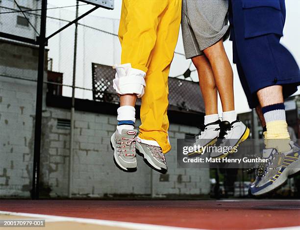 three people jumping in air on basketball court, low section - jogging pants 個照片及圖片檔