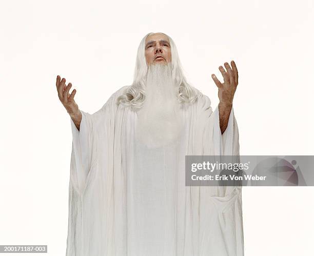 senior man wearing white robe with hands in air, looking up - diosa fotografías e imágenes de stock