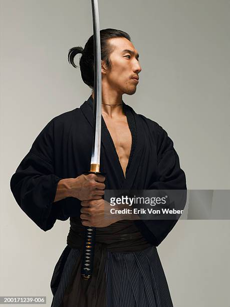 man holding sword, looking away - holding sword stock pictures, royalty-free photos & images